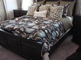 queen bed with headboard, sheets and drapes