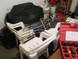 gas grill and plastic chairs