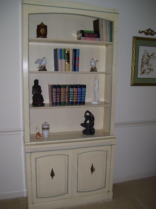White painted bookcase with miscellaneous items and books