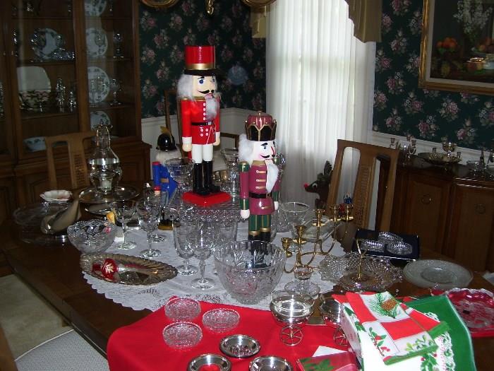 Assortment of glass serving pieces, silverplate serving pieces and Nutcrackers