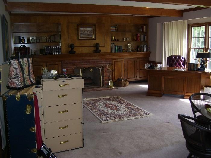 Family room with the Oshkosh wardrobe trunk, leather sofa, desk and office chair, games table and chairs