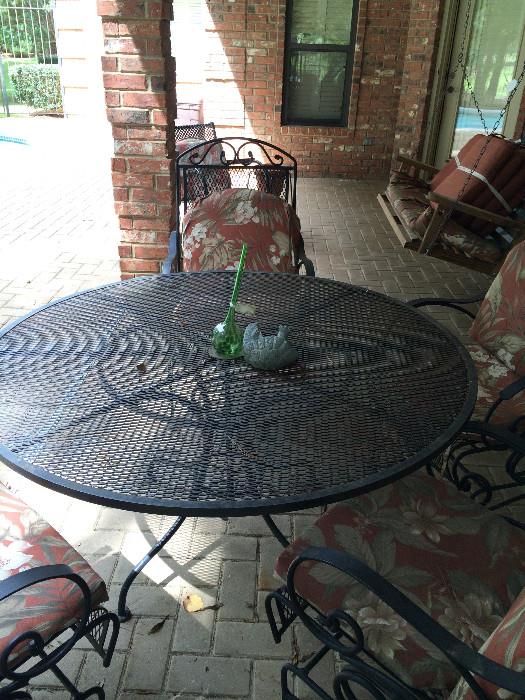     Round patio table, spring chairs; porch swing
