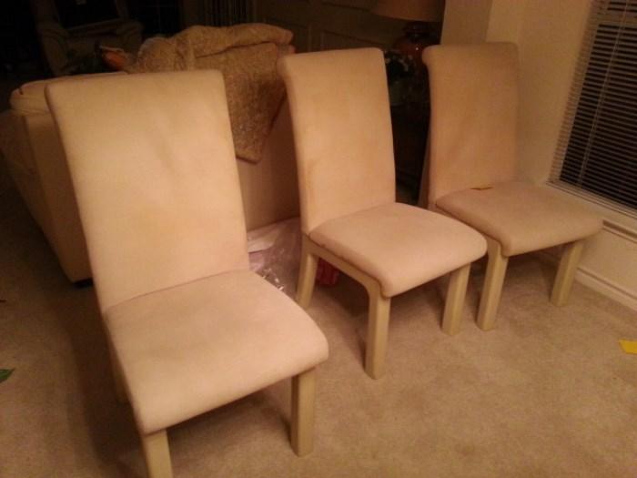 Set of four high back upholstered chairs. White?Creme color. Very sturdy.
