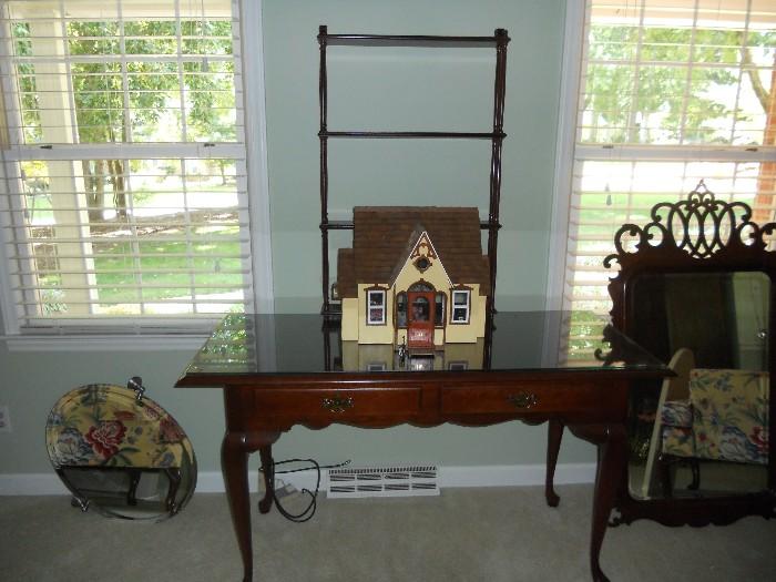 Mahogany Desk with Glass top--can be used as occasional table.  Hand crafted miniature house fully furnished sits atop table