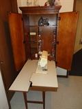 Singer sewing machine in wall cabinet for easy storage