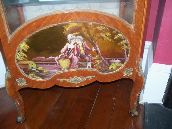 ormolu display case with wood etchings in front and on the sides