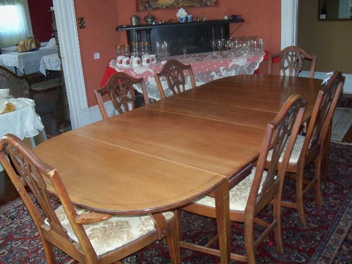 Mid-century dining room table and 6 chairs.  I believe they are walnut.