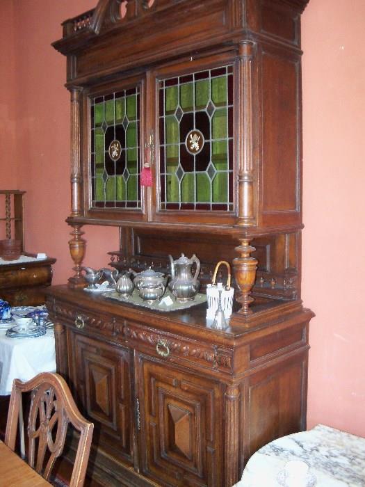 antique German Austrian buffet with stained glass show casing the mighty lion in the middle 