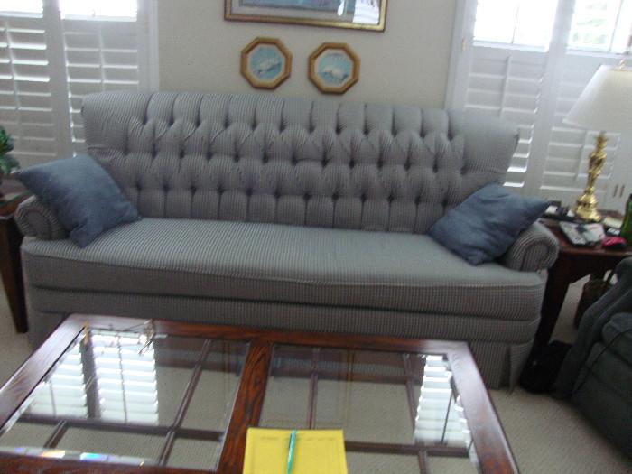 Blue couch with tufted back