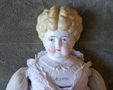 Detail of china head doll, showing name on shoulder head