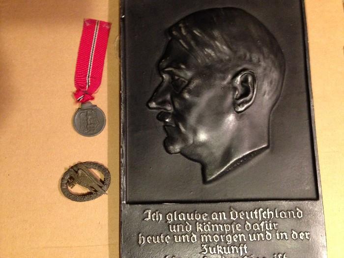 Large plaster bust plaque of Hitler (translation on back), Nazi medal for service in east (red ribbon), Nazi paratrooper insignia. Have also added some US WWII medals and other WWII ephemera.
