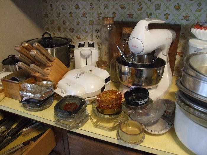 KITCHEN FULL OF GOODIES AND ONE OF A KINDS, MELMAC, TUPPERWARE, ASHTRAY COLLECTION, KNIVES, FLATWARE.
