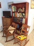 two antique rockers, tall book case and old ice box. 