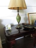 Glass top end table with brass base table lamp