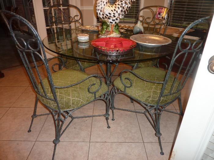 iron with glass table, nicely cushioned chairs