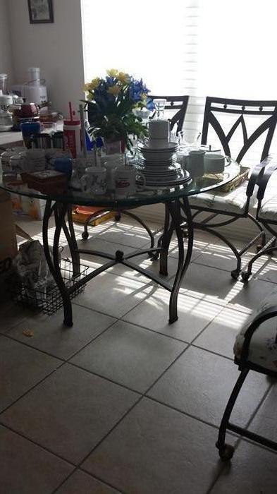 Wrought iron glass top dining set, 4 chairs and Baker's Rack