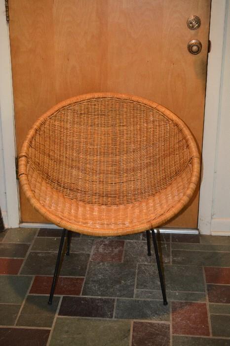 One of a pair Mid Century woven wicker chairs on metal legs
