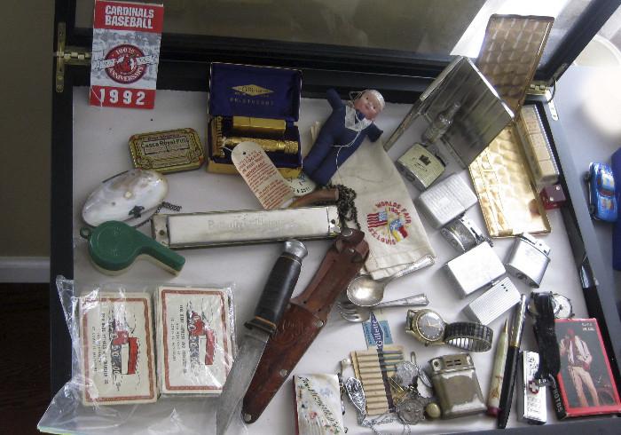 Lighters, harmonica, knife/sheath, cigarette holders, Elvis cards, Gold Razor in case, etc.