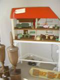 Vintage doll house with original wood furniture and jointed dollhouse dolls, Architectural elements in front.