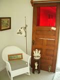 Wicker rocker, Iron floor lamp, Wonderful oak door with hard-to-find original red glass window