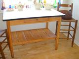 Enamel top kitchen table, youth or bistro rush seat chair. On table are Shawnee and Hall pottery pieces