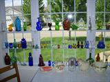 Collection of colored glass items in kitchen window