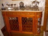 Lighted curio/buffet with faux parquet marble top. The Mario Buatta Collection by John Widdicomb. Displayed on top are assorted silverplate items