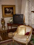 Corner of living room showing Klingman's chair, Widdicomb console table (under TV), Artwork of parade horse, and oriental vase on stand