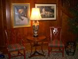 Widdicomb table, nice arm chairs, and 2 Bonnie Marris prints on wall