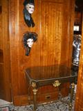 Antique inlaid top table (some losses to inlay) and two porcelain face mask wall plaques