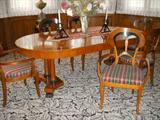 Widdicomb round table (with two leaves in it as shown) and 6 chairs in the Beidermeier style.