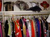 Fun clothing and hats in the walk-in closet, with sizes ranging from small to large