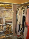 Closet in guest room showing pillows and more clothing