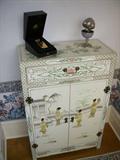 Chinoiserie decorated chest. On top is a Clive Christian perfume bottle in fitted box
