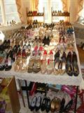 Approximately 250 pairs of shoes (the display shown here is on 8 card tables). Chanel, Prada, Dior, Manolo Blahnik, Ferragamo, Escada, and more. Shoes range in size from 6 1/2 to 8 1/2.