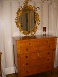 Birdseye maple and cherry Empire style 19th Century chest of drawers. Mirror has hummingbird and floral motif