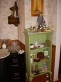 Cute green painted display shelf with figurines