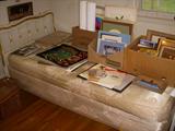 One of a pair of twin beds.  Many prints and frames