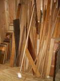 Another view of the contents of the shed. LOTS of wood for projects.  Boards to the far left are panels removed from old doors.