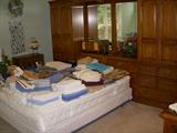 Thomasville Oak queen size bed with armoire headboard boasting lots of storage