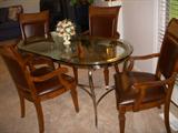 Oval glass top metal base table.  Chairs are by Stanley Furniture Co and match the "Villa Antica" dining set