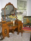 Ornate dressing table & bench with floral etched triple mirror.  To the right is a sailing ship motif folding card table