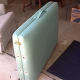 Massage table folded up and ready to go in included carry bag