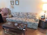 like new couch, pair of wingback chairs, coffee table, brass fireplace fender, end table