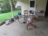 old tricycle, plant containers, side chairs