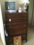        Antique chest; small TV; decorative lamps;