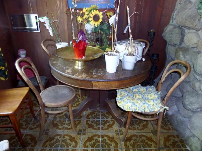 antique round oak table with four thonet bentwood chairs