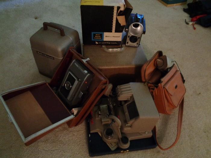 Vintage photography equipment.  2 projections screens and projection table available not in picture.  Vintage Polaroid cameras. 