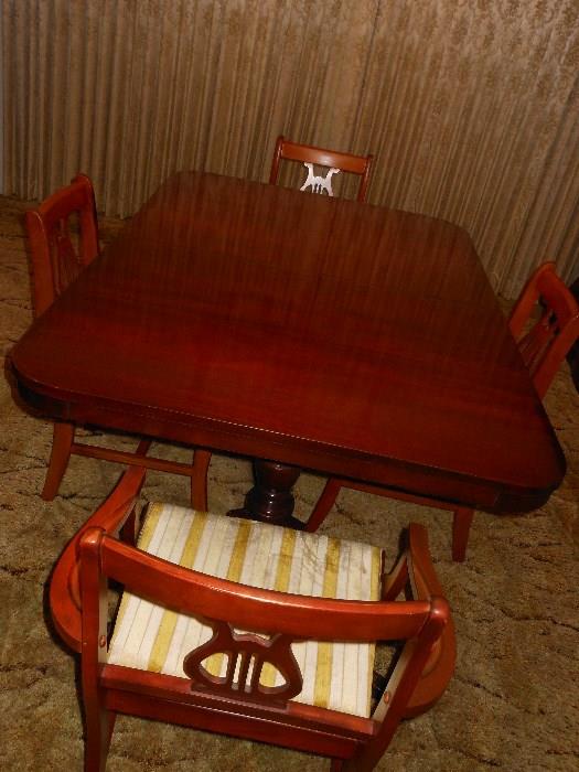 Duncan Phyfe Mahogany Dining room table and 4 chairs. Includes one leaf and custom table pads.