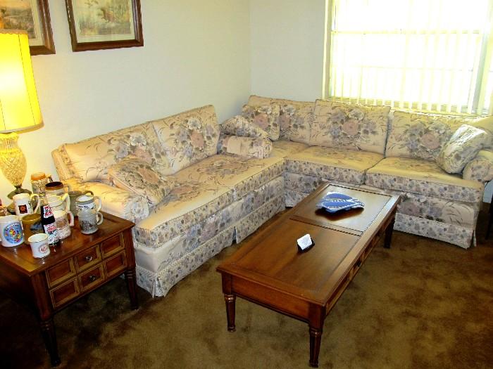 Traditional Style Living Room Set...includes large Sofa with tufted beige colored upholstery with muted floral patter; Matching Loveseat; Traditional Style Coffee Table with Pecan  finish; Matching Pair of End Tables with drawer storage (the other matching end table is pictured elsewhere in this collection; Accent Table Lamp, Artworks and collection of Beer Steins  are also available.